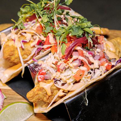 Fish tacos, with chipotle sauce, and mixed vegetables.
