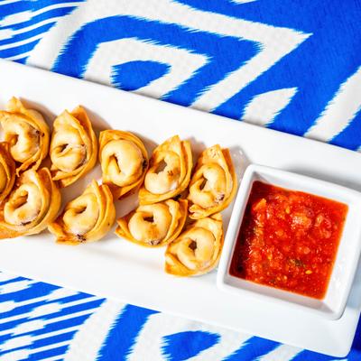 Deep-fried Uzbek dumplings served with tomato sauce.