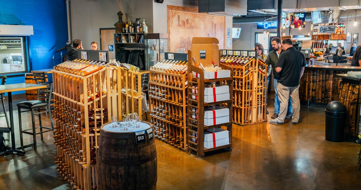 Interior, a room with wooden racks displaying various bottled drinks