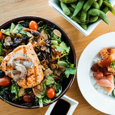 Grilled salmon salad, Rice salmon bowl, and edamame, top view.