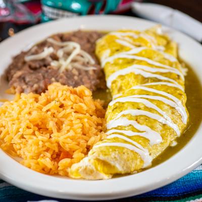 Enchilada omelet drizzled with cream, served with rice and refired beans.