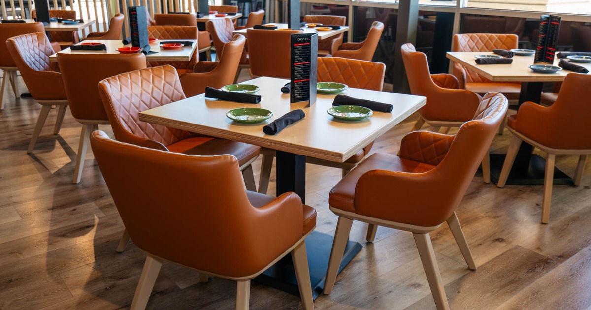 Interior, dining area, wooden top tables with leather padded chairs, ready for guests