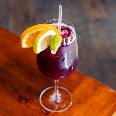Red sangria, garnished with orange, lemon, and lime.