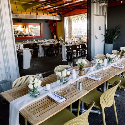 Elegant dining setup with white roses and candles.