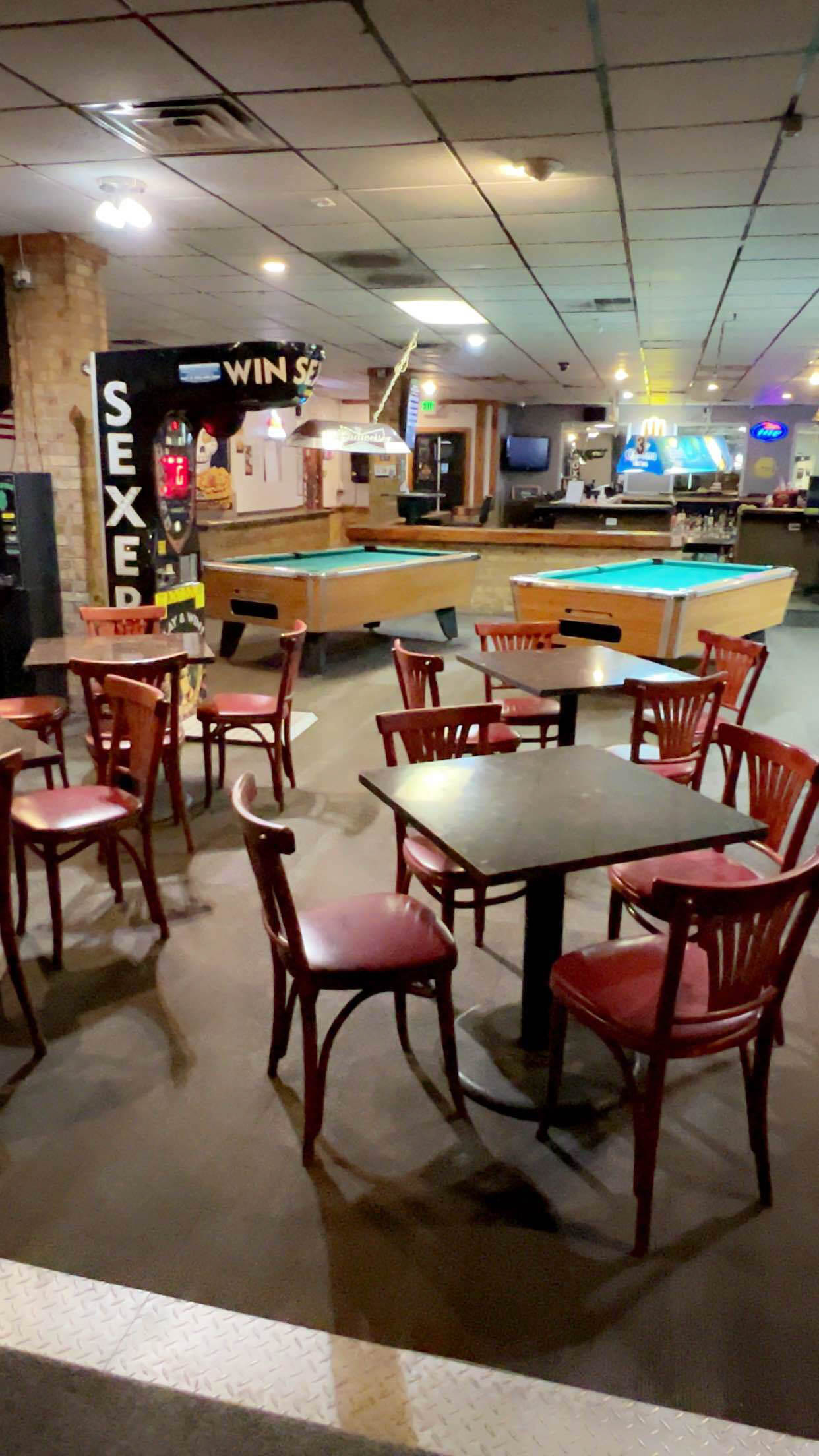 Interior with seating area, pool tables and Boxer arcade machine