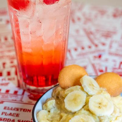 Banana pudding with a glass of cherry soda.