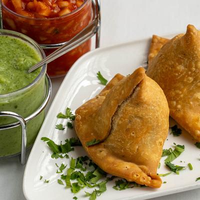 Vegetable Samosa with chutneys on the side.