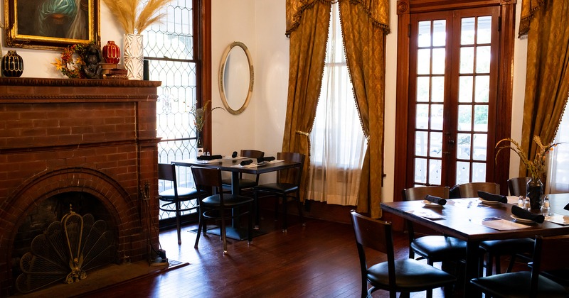 Restaurant interior, dining area with set tables and fireplace