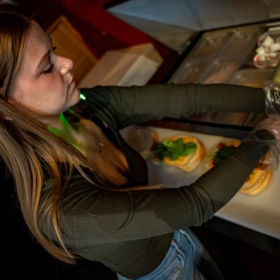 An employee preparing food.