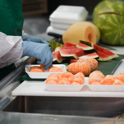 An employee preparing mandarin oranges for packaging.