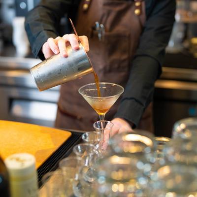 A bartender preparing a cocktail.