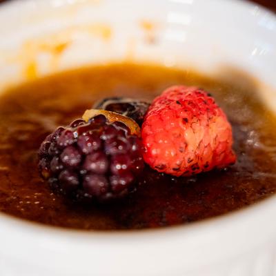 Earl Grey Creme Brulee garnished with berries.