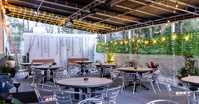 A patio cover, seating with tables and  chairs