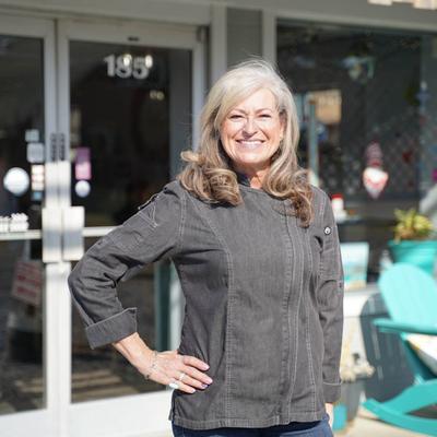 One of the owners standing outside the restaurant and smiling at the camera.