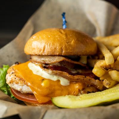 Chicken club with smoked bacon, lettuce , tomato and cheese, served with fries