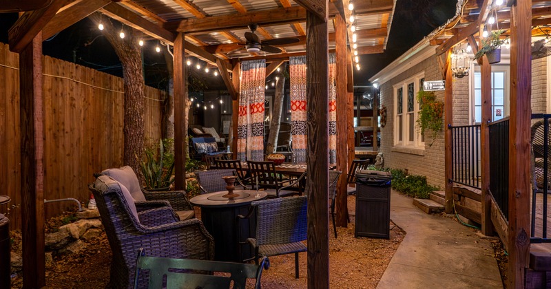 Cozy outdoor patio at night with wicker seating