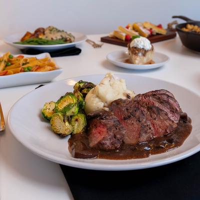 Steak Demi Glace served with mashed potatoes, and brussels sprouts.