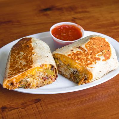 Breakfast burrito served with salsa on the side.