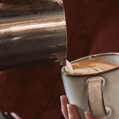 Milk being poured into a coffee.