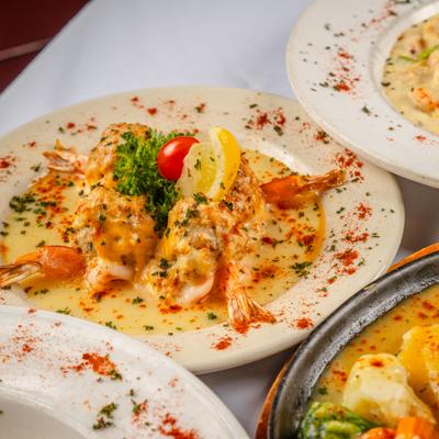Stuffed Shrimp Chef Monte served on the table alongside other dishes.