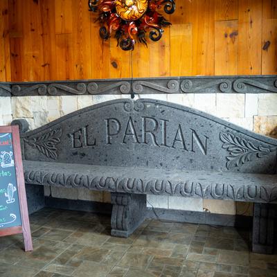 Stone bench by the wall with logo.