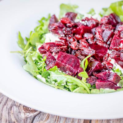 A close up of beet and arugula salad.