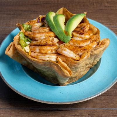 Shrimp Salad served in fried tortilla bowl, topped with sliced avocado.