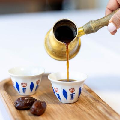 Person pouring coffee in cup