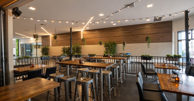 Exterior, indoor patio, tables and chairs ready for guests, lanterns, plant decoration