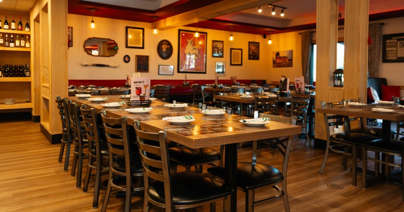 Interior, dining area, long table setup for ten people, wooden chairs with padded seats