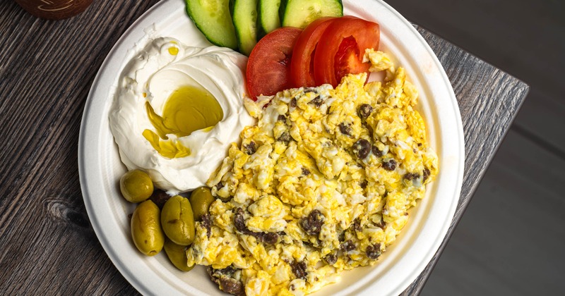 Scrambled eggs with minced lamb, tomato, cucumber, olives, and strained yogurt
