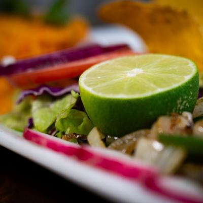 Lime half resting on mixed vegetables.