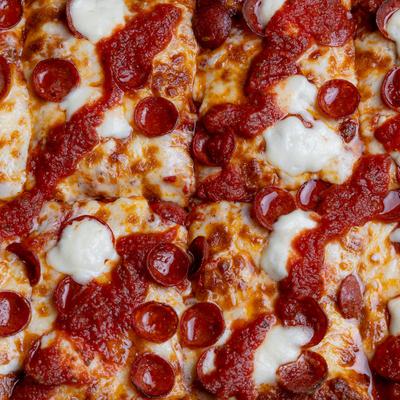 Detroit-style pepperoni pizza with cheese and tomato sauce.