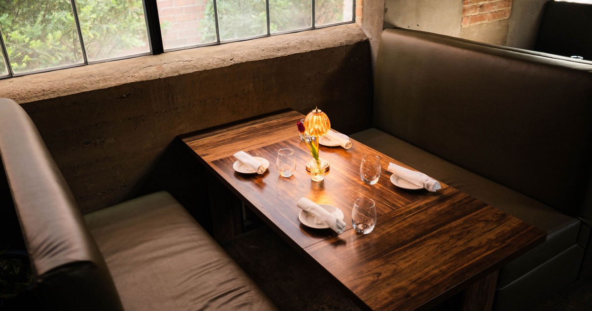 Stylish and cozy dining booth set for four guests