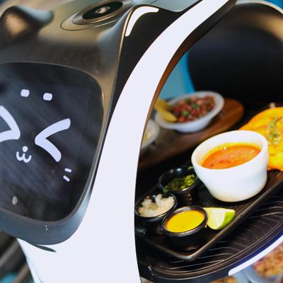 An electric smart serving appliance carrying food and drinks.