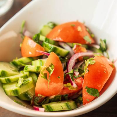 Georgian Classic Salad with cucumber, tomato, red onion and herbs.
