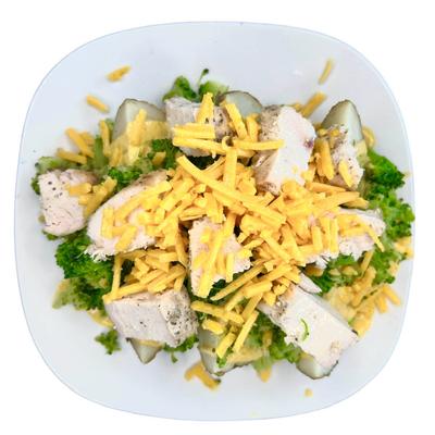 Chicken with broccoli and shredded cheese.