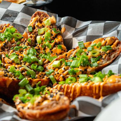 Toasted bread topped with cheese and green onions.