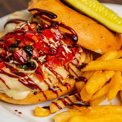 Bruschetta chicken sandwich, close up.