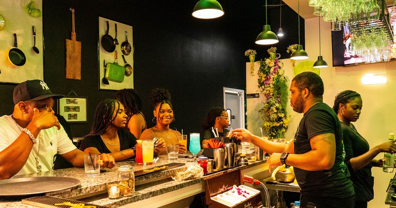 Bar, bartender serves cocktails to guests