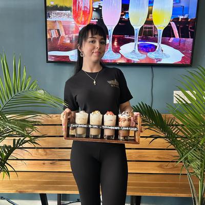 A server holds Iced Boozie Coffee Flight.