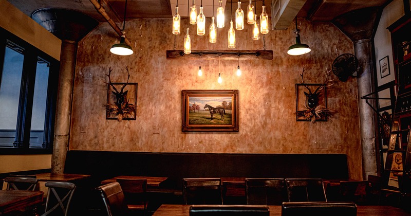 Interior, dining seating by a wall decorated with taxidermy