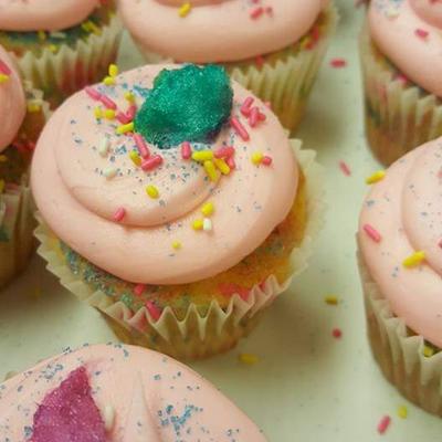 Close-up of colorful cupcakes with pink frosting.