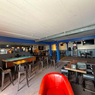 Interior featuring a pool table and dartboard area, along with table seating.