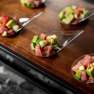 Tuna and avocado salad served in teardrop-shaped plastic spoons.