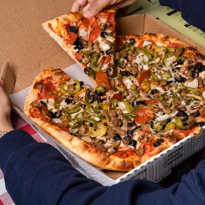 Pizza with olives, onion, pepperoni, green peppers, sausage, and mushrooms.