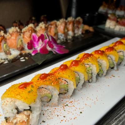 Crab meat and shrimp tempura rolls topped with mango.