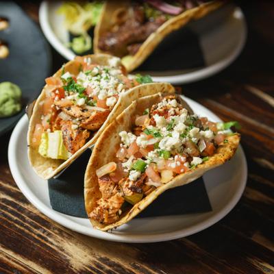 Two chicken tacos on a plate.
