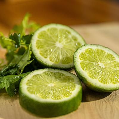 Fresh lime slices and cilantro, a close up.