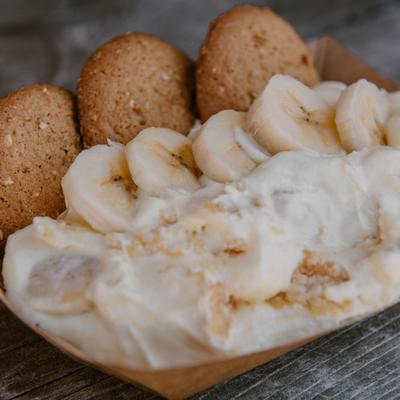 A serving of banana pudding topped with vanilla wafer cookies.